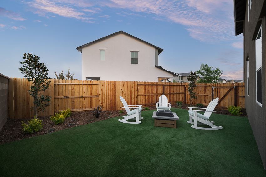 Pet Friendly Homes in Roseville CA - Cyrene at Fiddyment - Spacious Backyard with Turf, Wood Fence, Patio Furniture, and a Fire Pit. - Photo Gallery