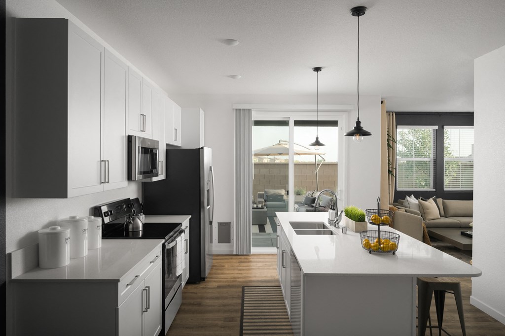 cyrene at fiddyment model kitchen and living room with island and white countertops