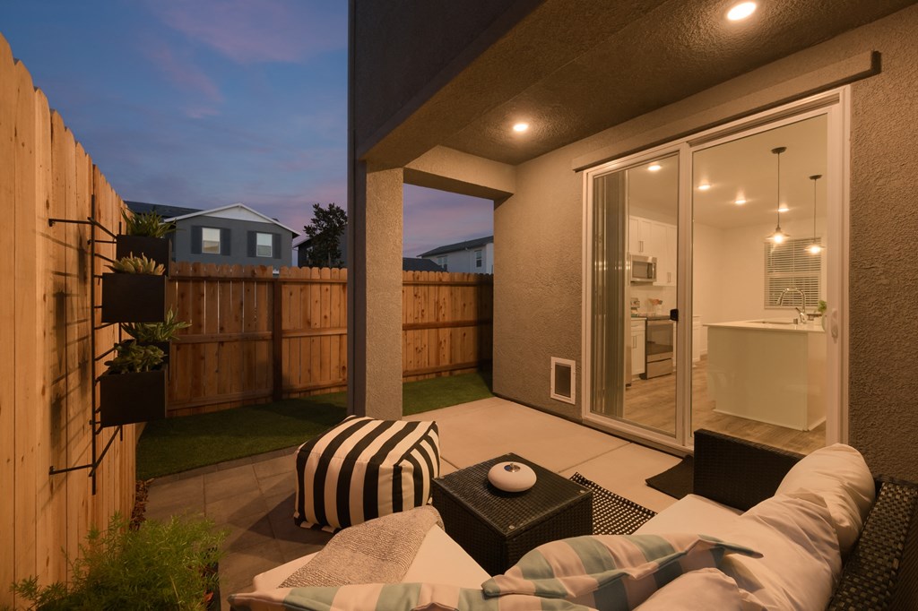 cyrene at fiddyment model backyard with outdoor furniture and sliding door