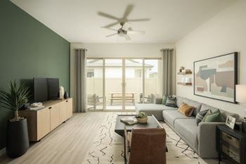 A modern living room with a flat screen TV and a large window.