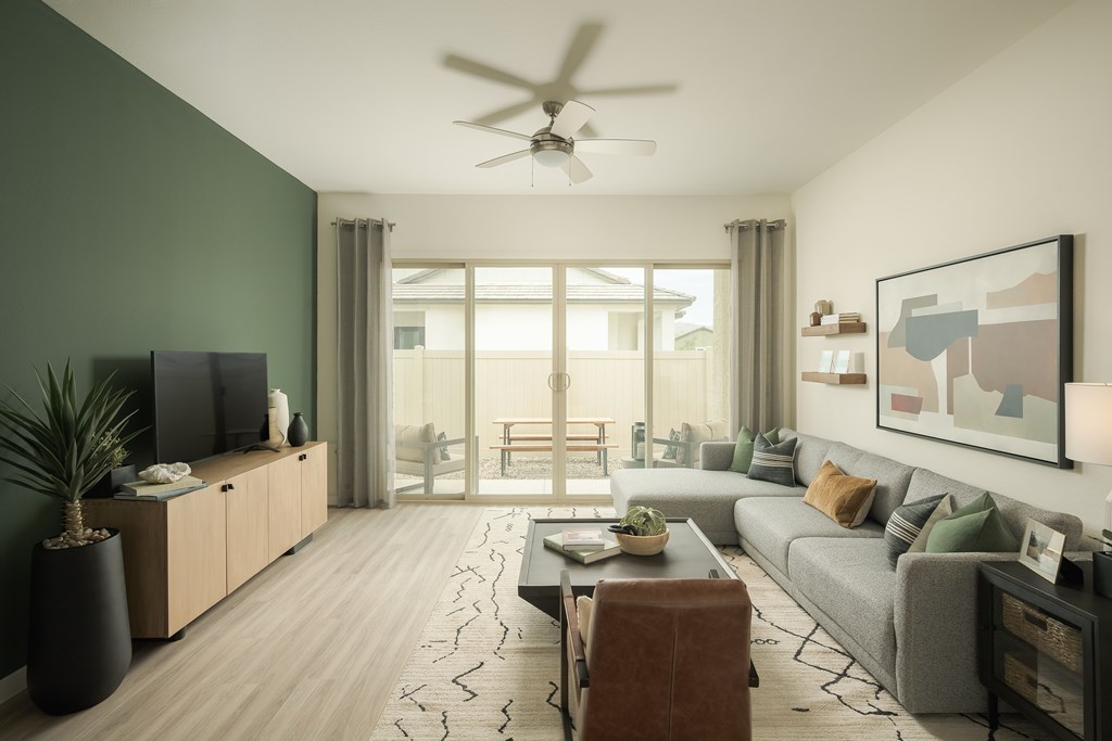 A modern living room with a flat screen TV and a large window.