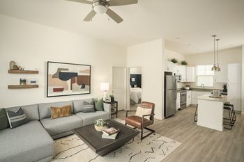 A modern living room with a grey sofa and a coffee table.
