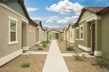 A row of houses with a pathway in the middle.