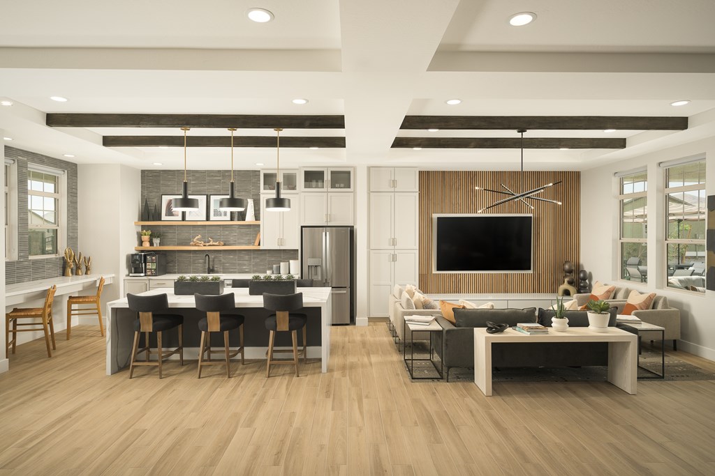 A modern kitchen and living room with wooden floors and furniture.