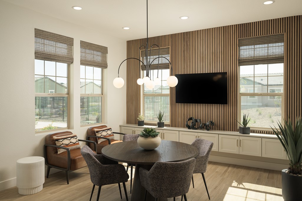 A modern dining room with a wooden table and chairs.