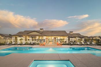 A large house with a swimming pool in front.