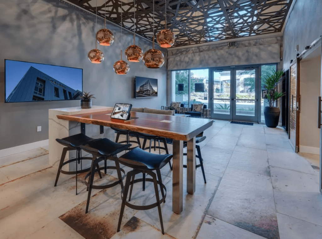 a large dining room with a wooden table and chairs