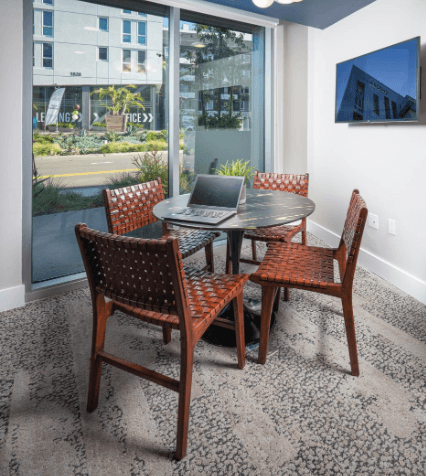 a dining room table with a laptop on top of it