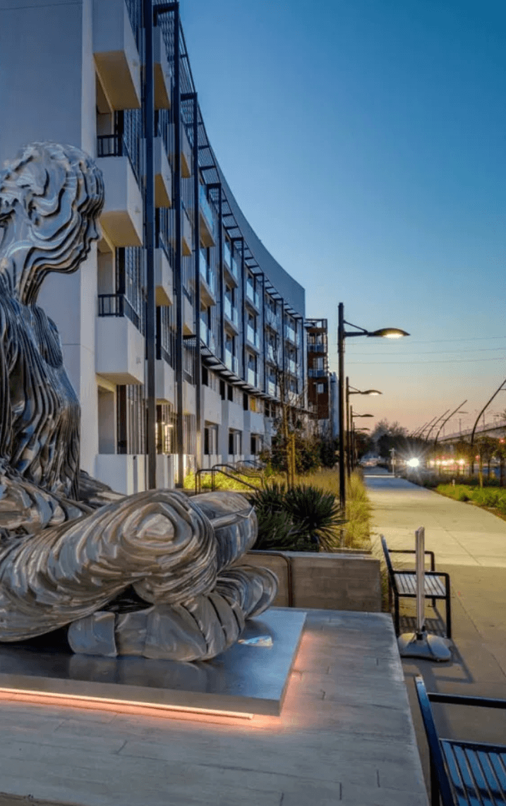 a statue in front of a building at night