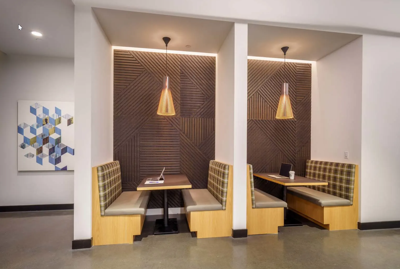 a room with two tables and two chairs and a painting on the wall