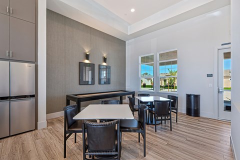 A dining room with a table and chairs.