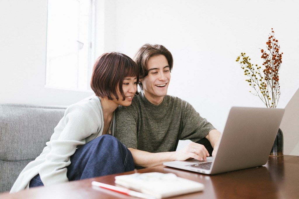 couple sitting and looking at laptop