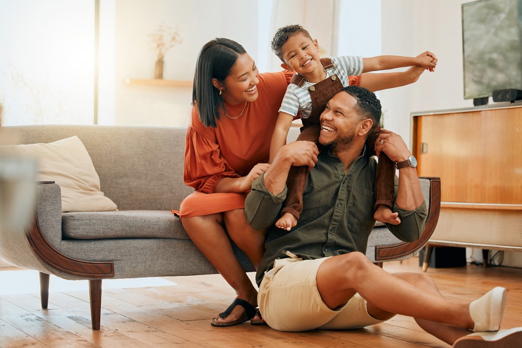 a family sitting on the floor in their living room