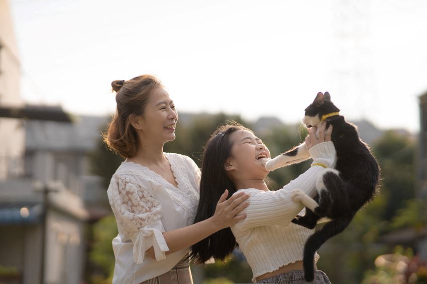 mom and daughter outside holding pet cat - Photo Gallery