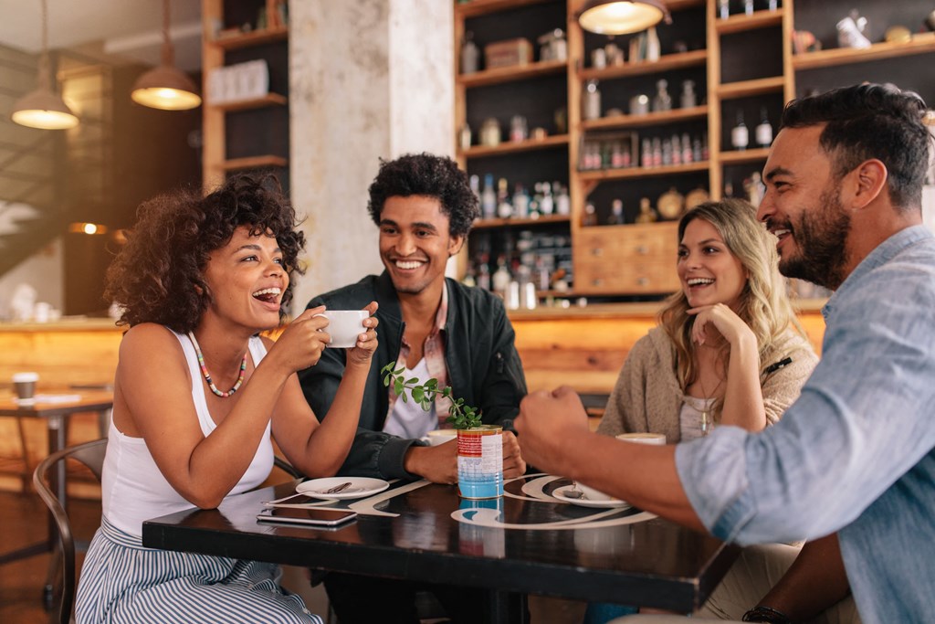 a group of people sitting around a table in a restaurant