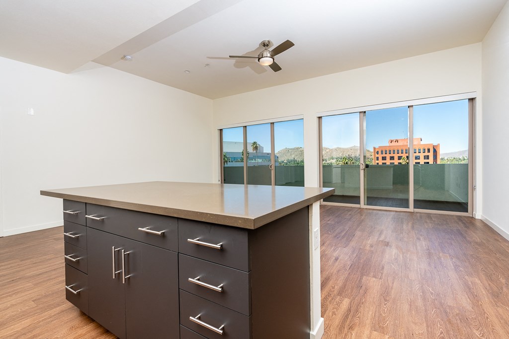 kitchen island and  livingroom with wood style floor and large windows