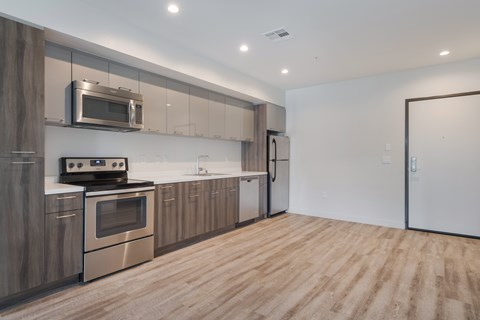 A modern kitchen with wooden cabinets and stainless steel appliances.