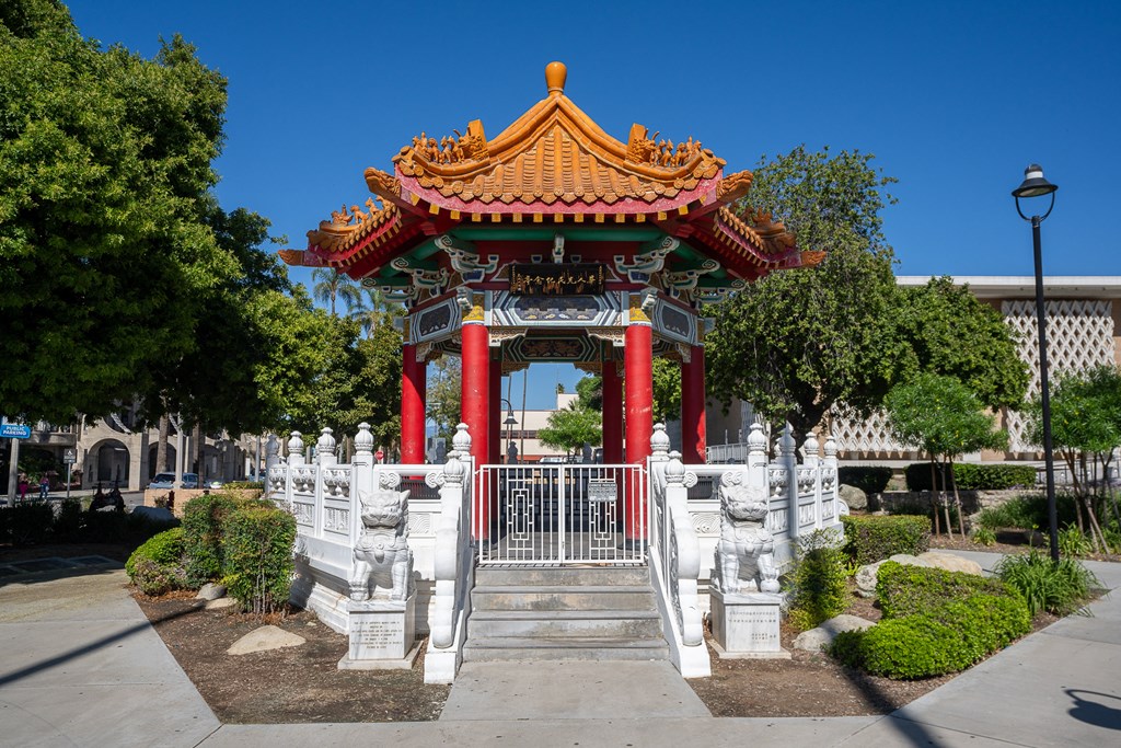 an ornate pagoda in the middle of a sidewalk in front of a building at Main+Nine, Riverside, CA