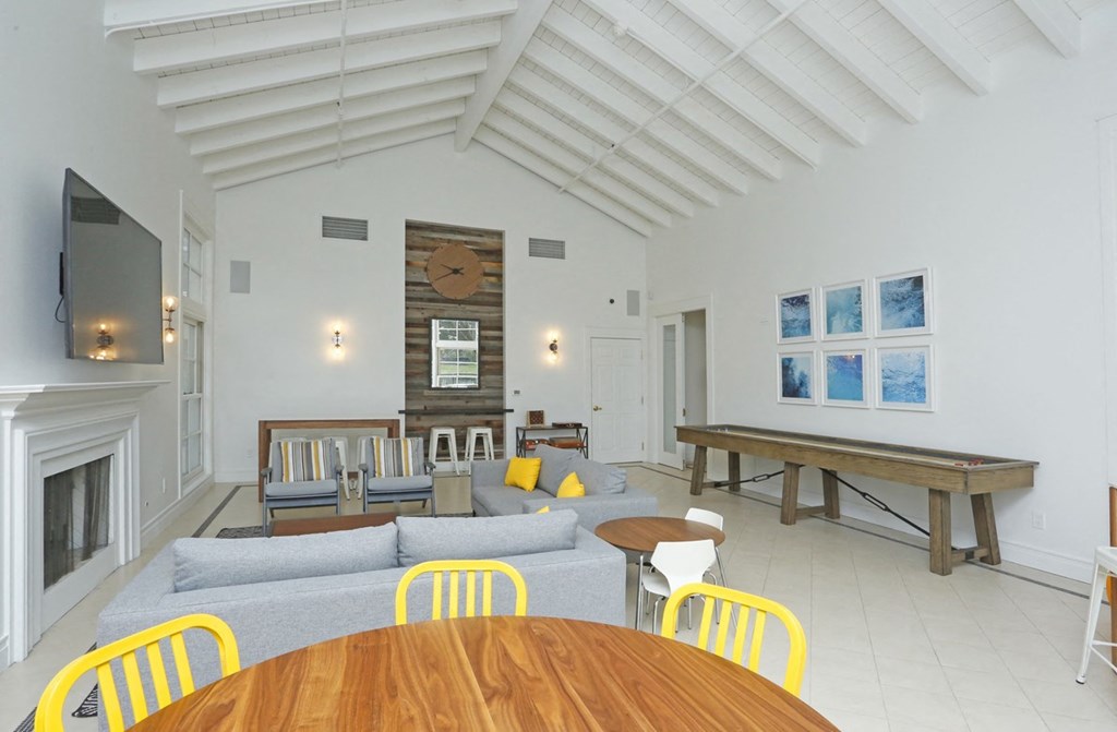 a living room with a couch and a table and a fireplace