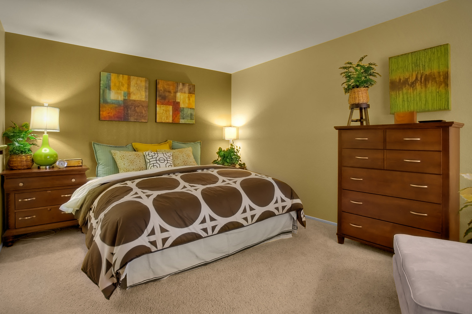 a bedroom with a bed and two dressers