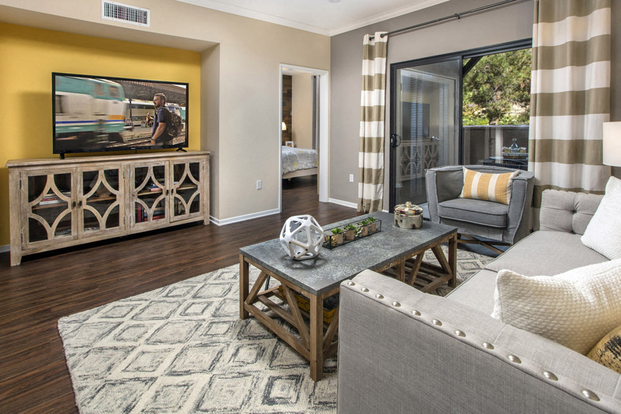 Living area with TV and sliding glass doors to patio