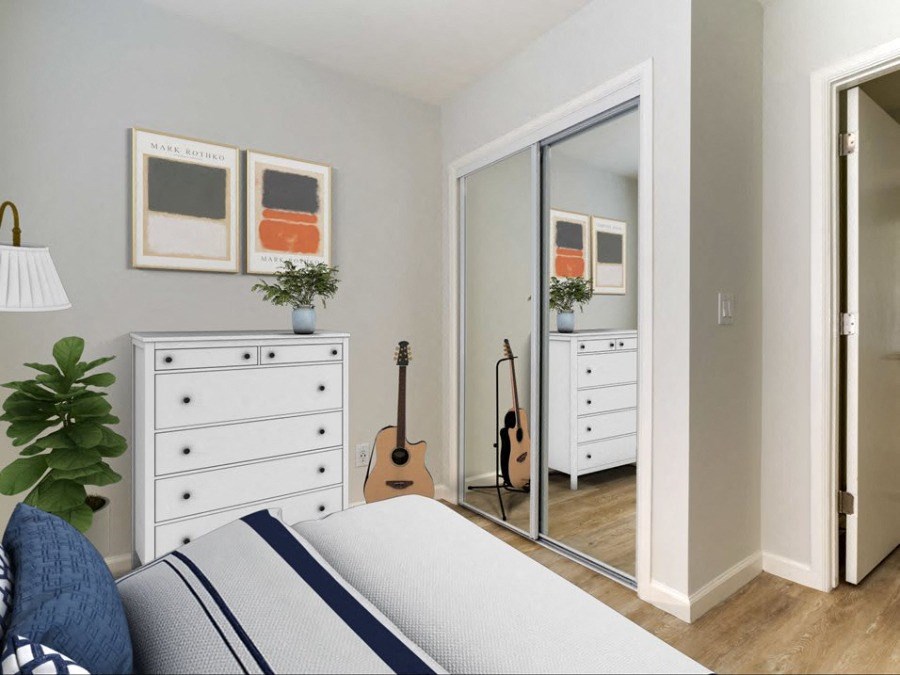 a bedroom with a bed and a mirror