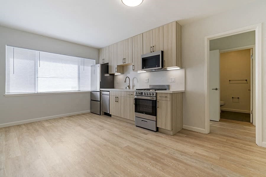a kitchen with a stove top oven next to a window