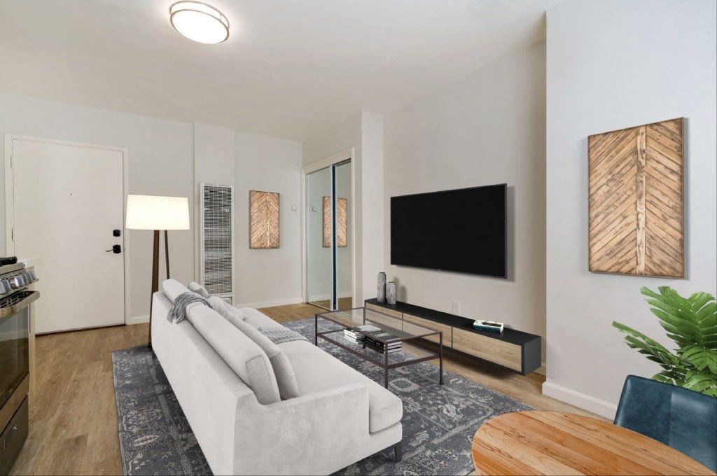 a living room with a couch and a tv on the wall