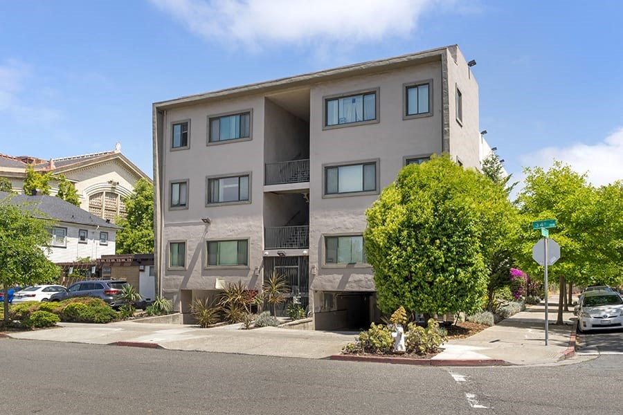an apartment building on a street corner