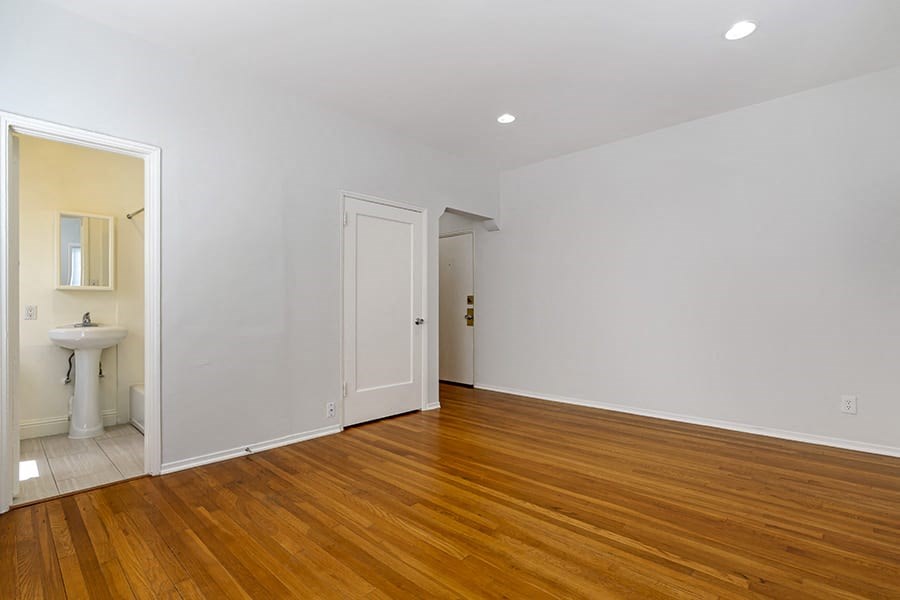 a bedroom with a sink and a mirror