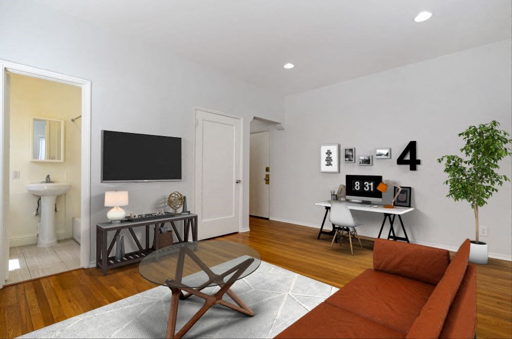 a living room with a couch and a tv on the wall