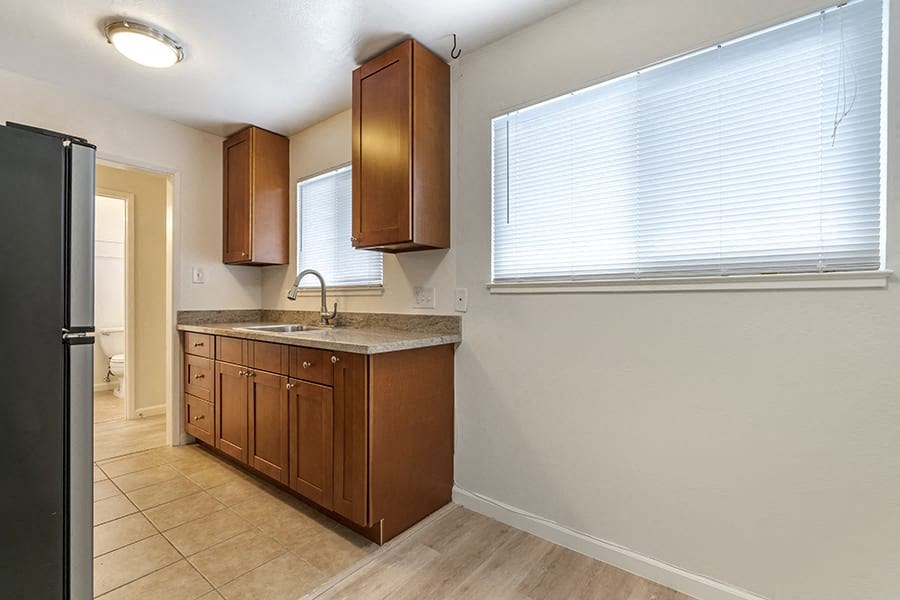 a kitchen with a sink and a refrigerator