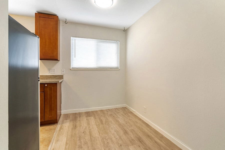 a kitchen with a refrigerator freezer next to a window