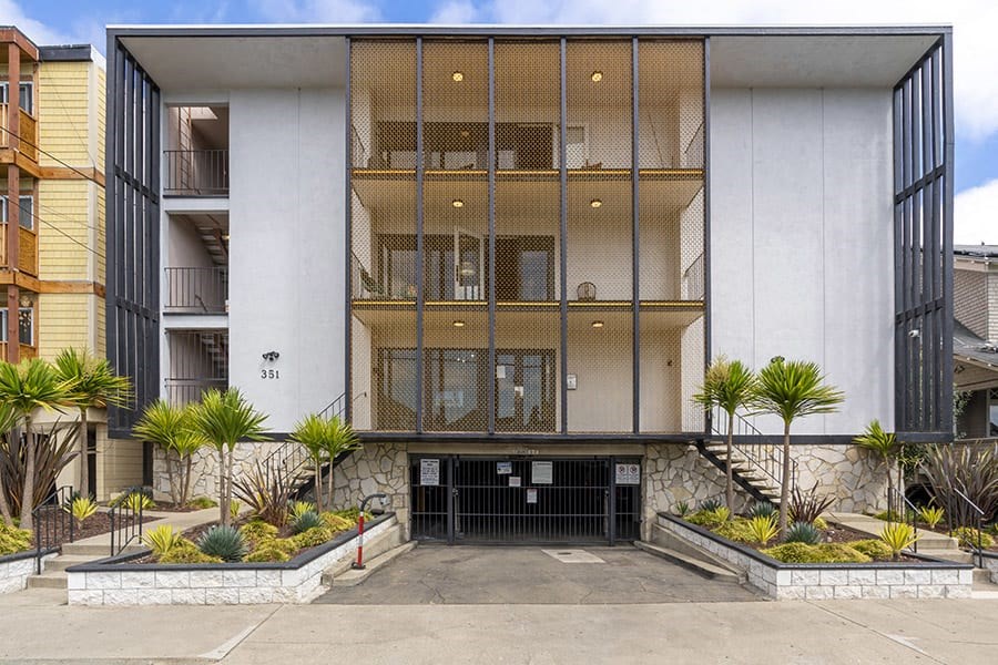 a large white building with a black garage door