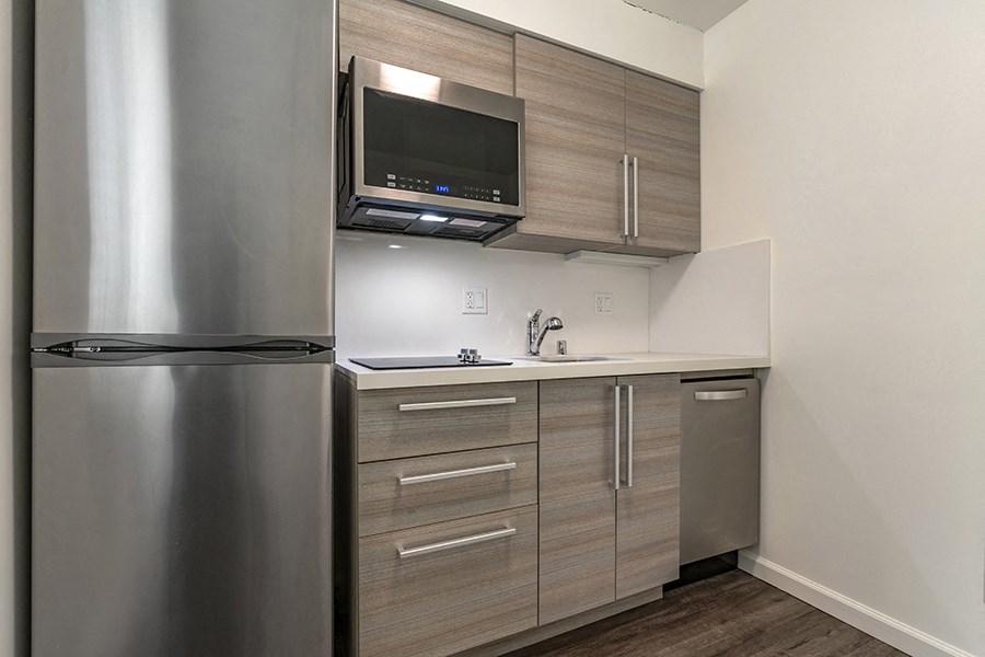 a kitchen with a refrigerator freezer and a sink