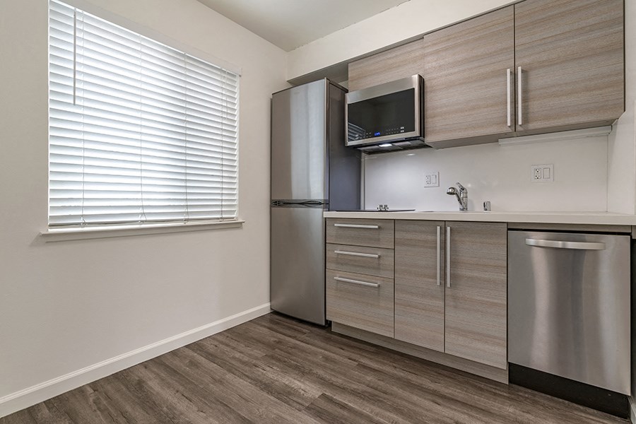 a kitchen with a refrigerator freezer and a dishwasher