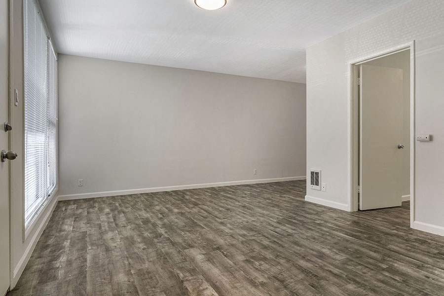 a bedroom with gray walls and a large window