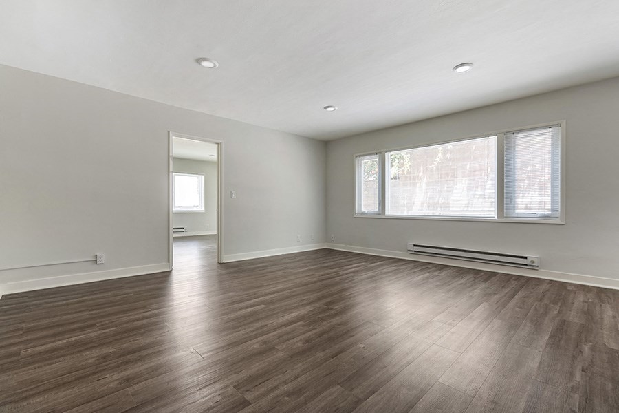 a bedroom with hardwood floors and grey walls