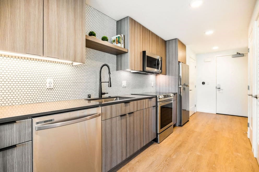 a kitchen with wooden cabinets and stainless steel appliances