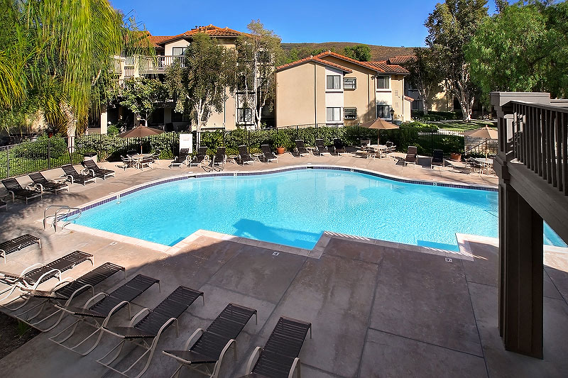 a large swimming pool with chairs around it