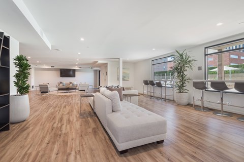 A modern living room with a white sofa and wooden floors.