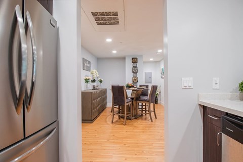 A kitchen with a table and chairs in the middle of the room.