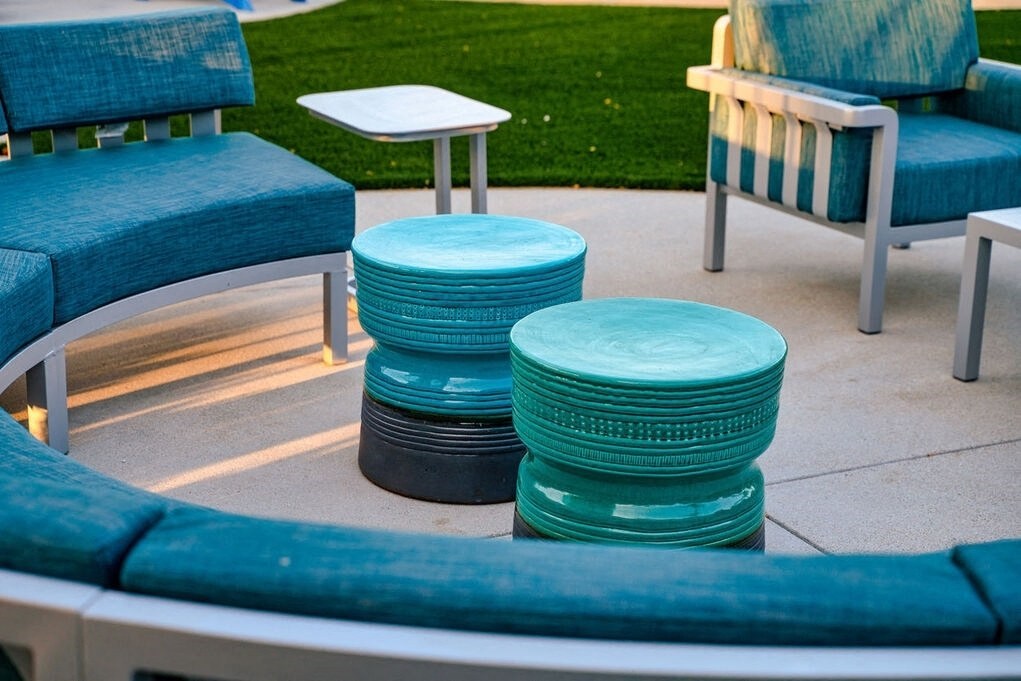 A set of outdoor furniture including a sofa, chairs and tables at Nola 624 Apartments, California