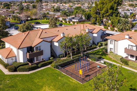 Aerial view of residential buildings with playground at Woodbend Apartments, Alta Loma, California