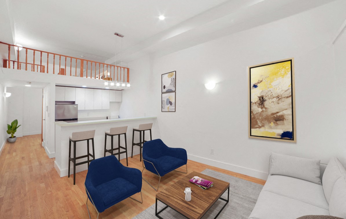 A living room with a white couch and a coffee table.
