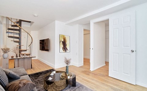 A living room with a grey couch and a coffee table.
