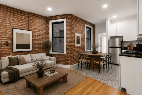 A living room with a white couch and a coffee table in front of a brick wall.