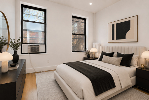 A bedroom with a large bed and a painting on the wall.