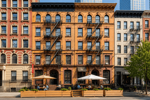 A row of buildings with a patio in front.