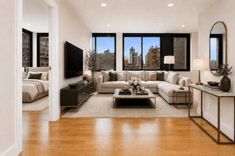 A modern living room with a large window and a view of the city.